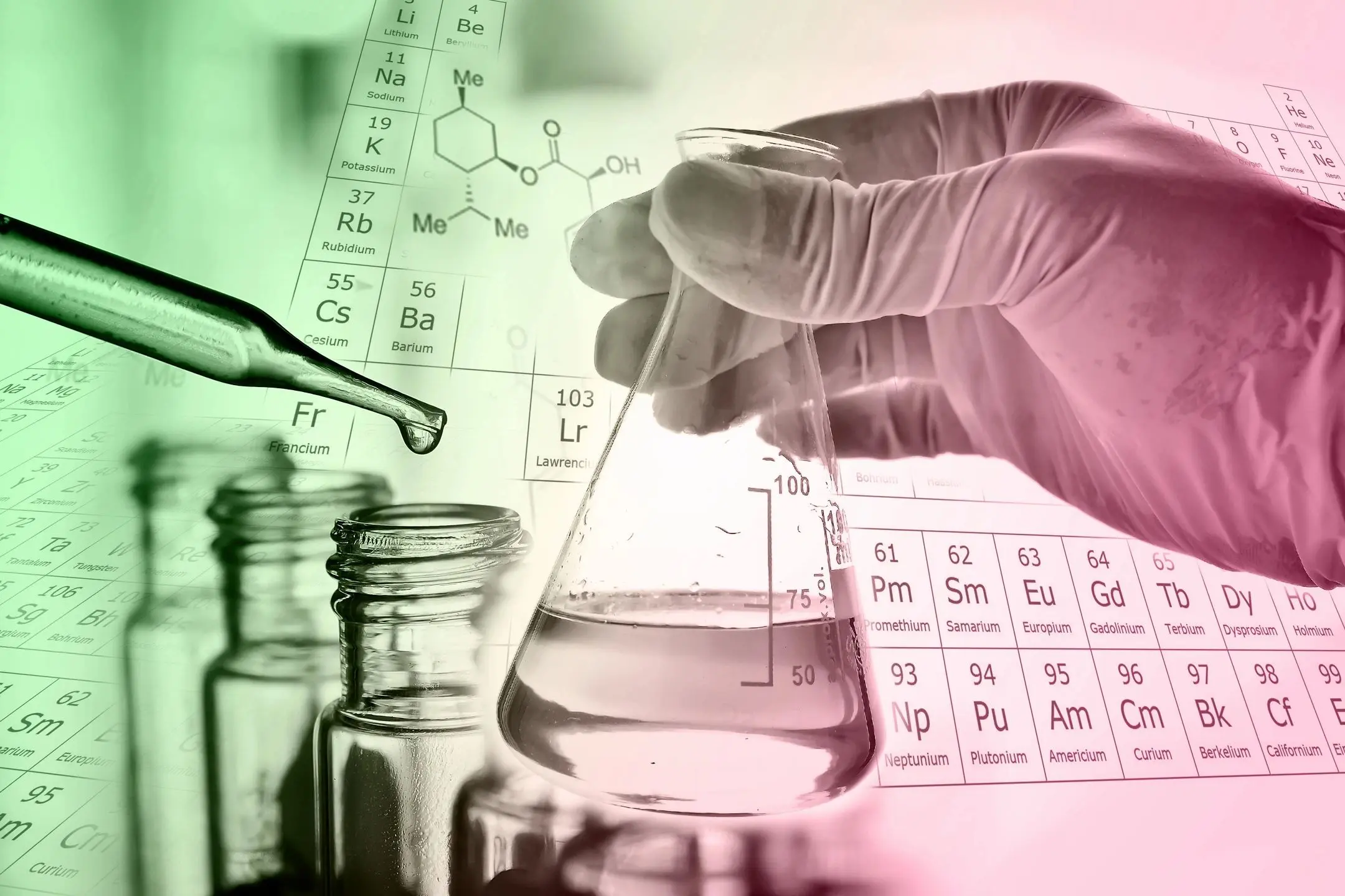 Scientist holding a flask in a lab with chemical elements in the background.